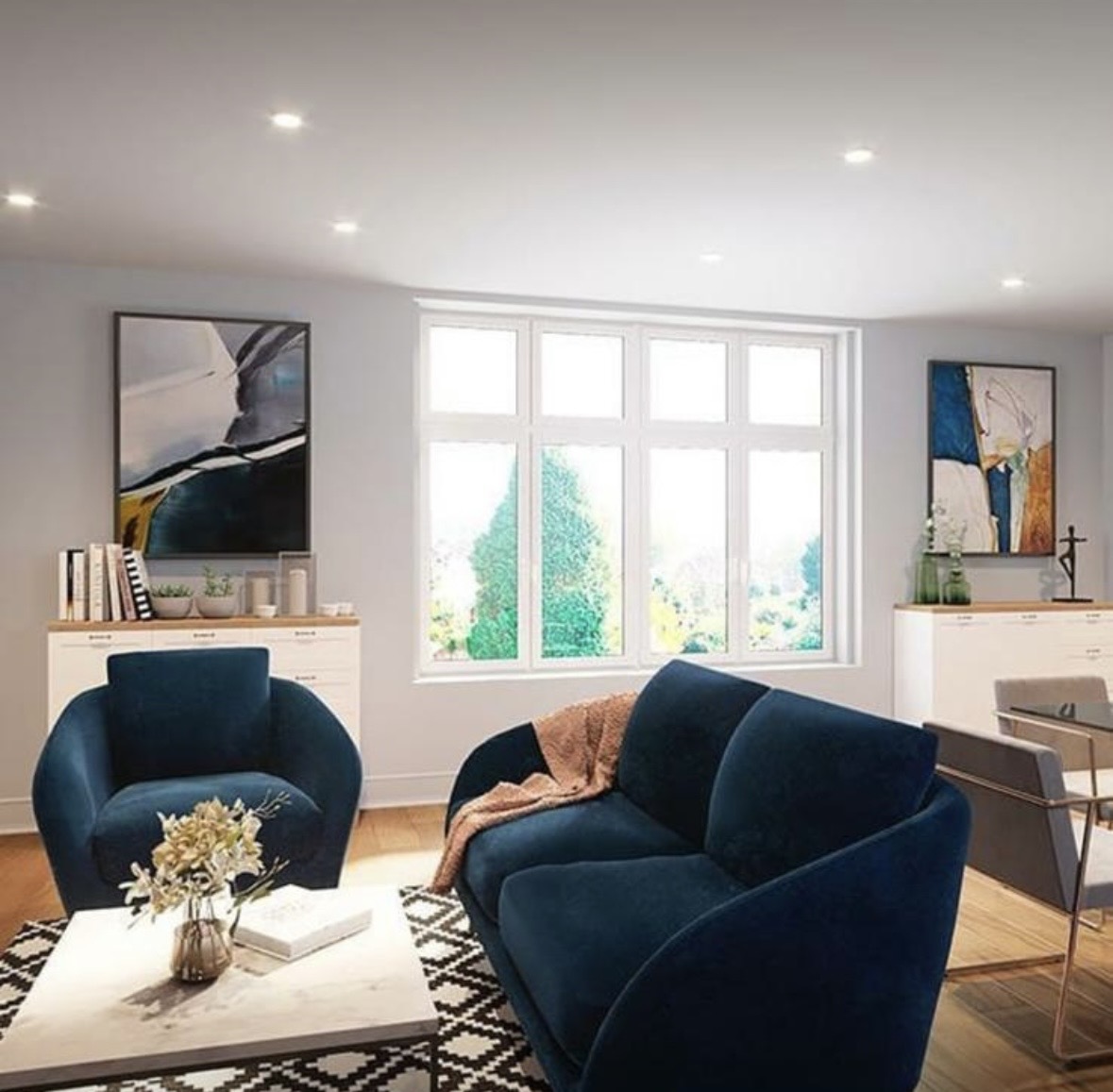 Finished apartment living room with blue upholstery, marble coffee table and bright glazing