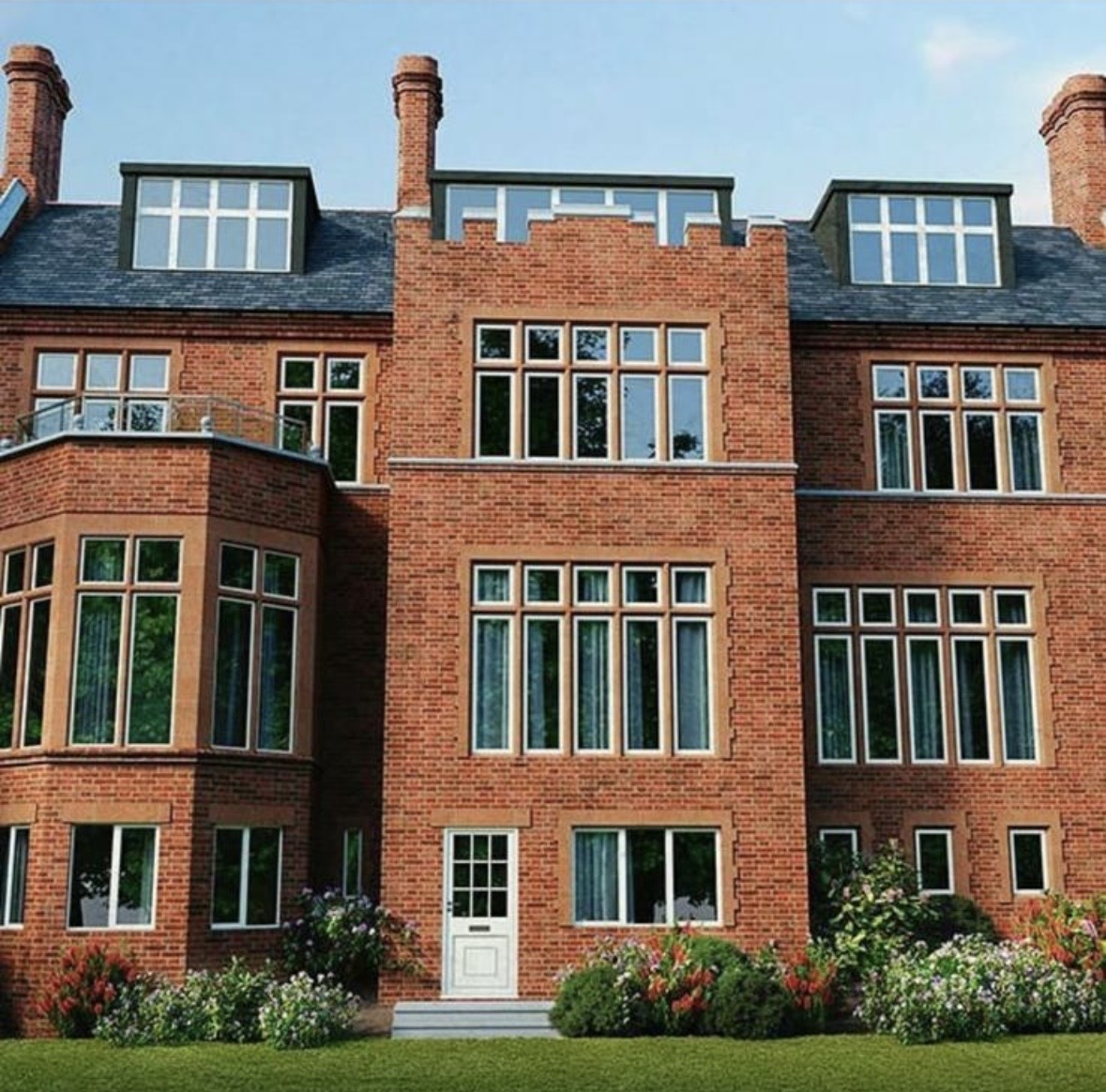 Completed red-brick apartment building with stone window surrounds, slate roof and landscaped entrance